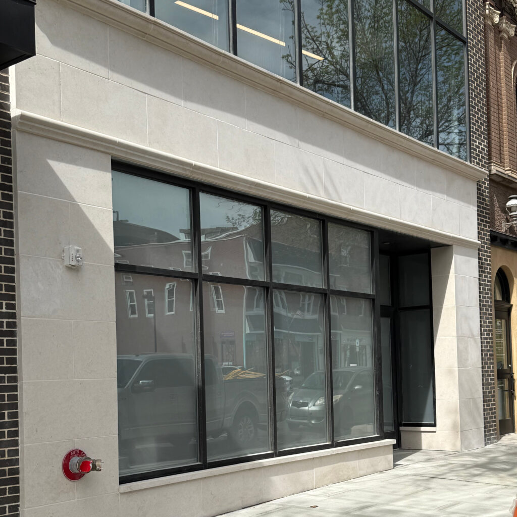A newly renovated limestone surface on the storefront of a business