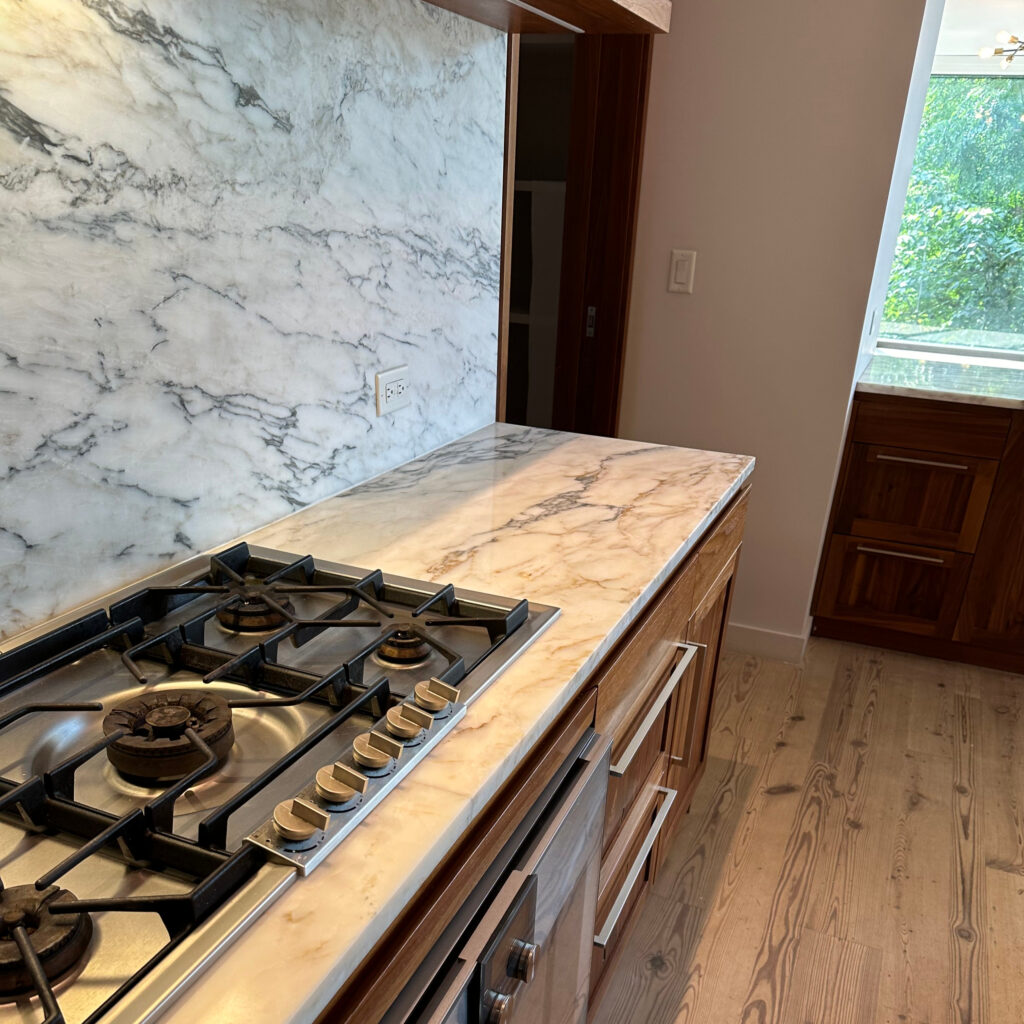 Brand new white marble countertop and backsplash in a kitchen